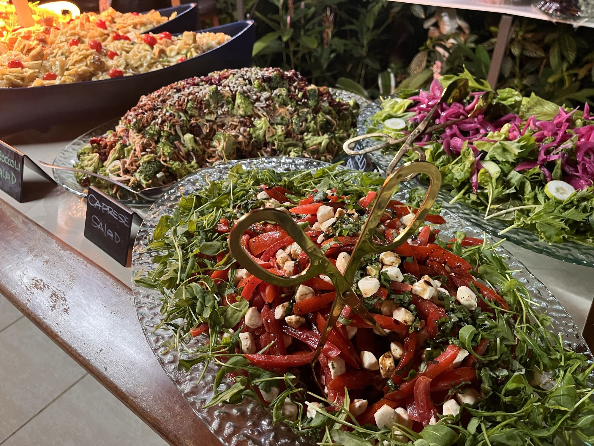 A composed salad service laid out along a restaurant buffet line
