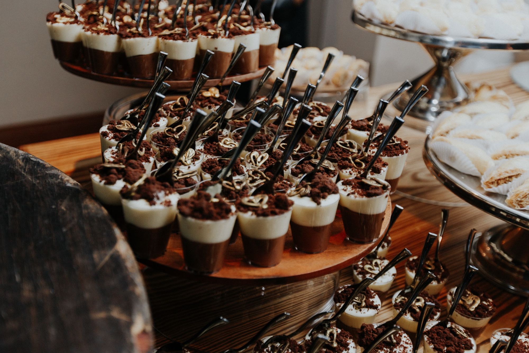 A tiered dessert display of chocolate mousse cups plated for a Chef Chelsae Marie event