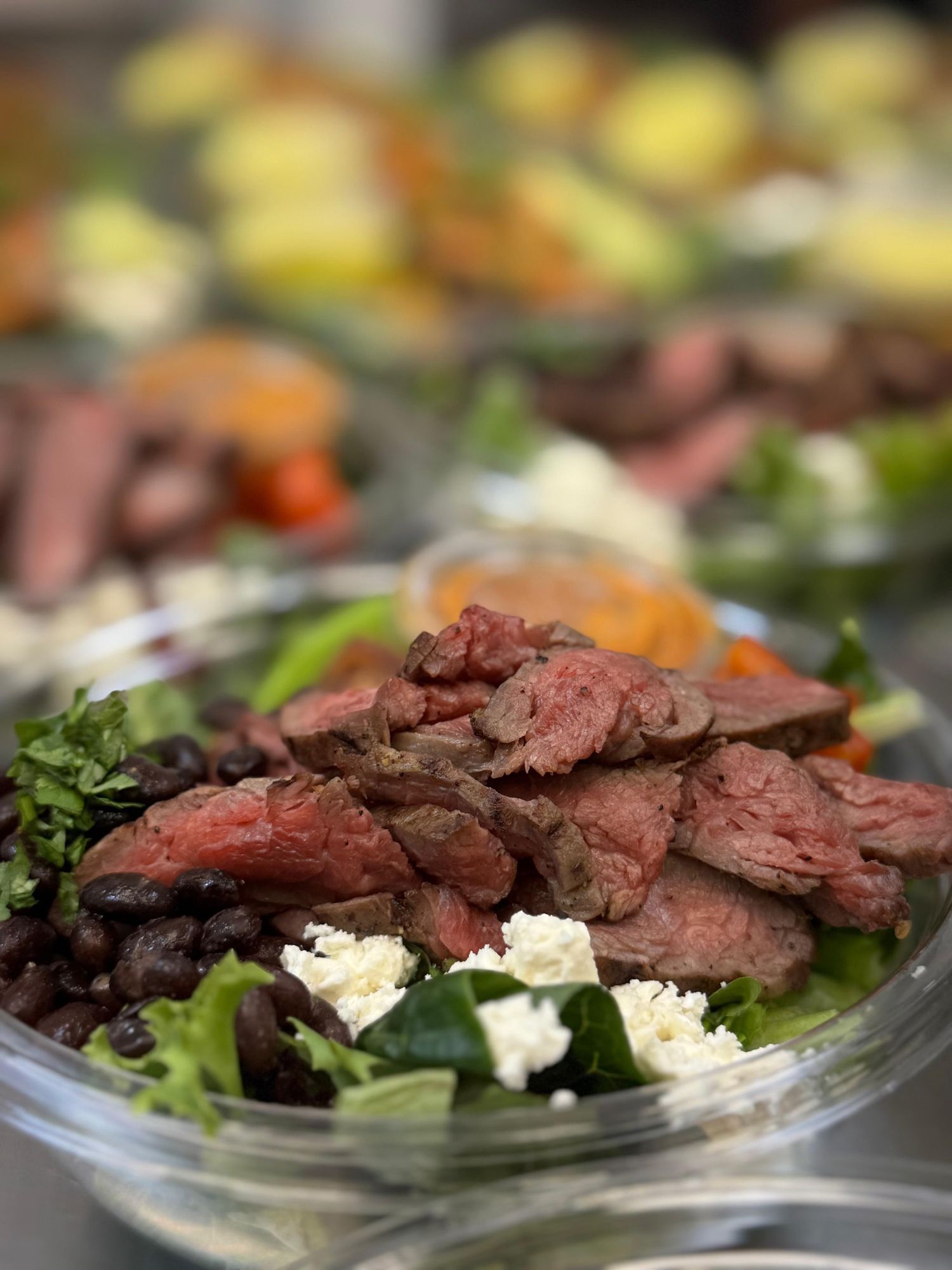 A balanced chef-made steak bowl with black beans and feta, packed ready to grab